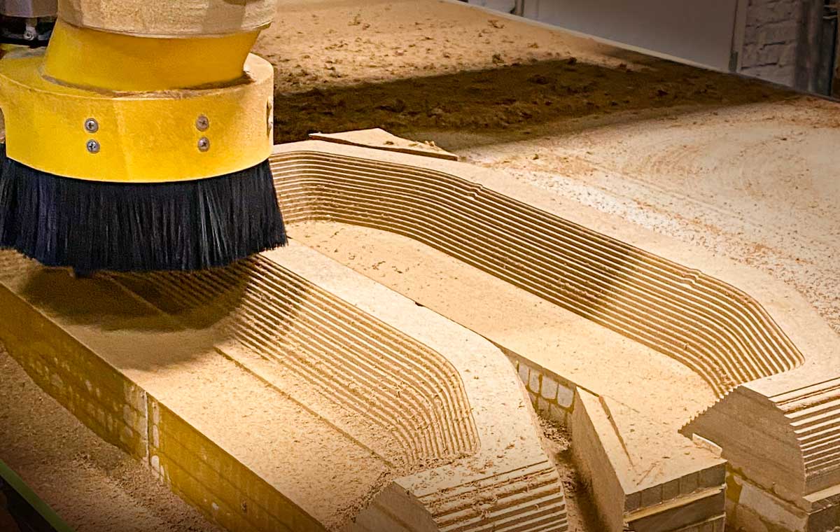 A CNC machine carves into wood in a shop setting