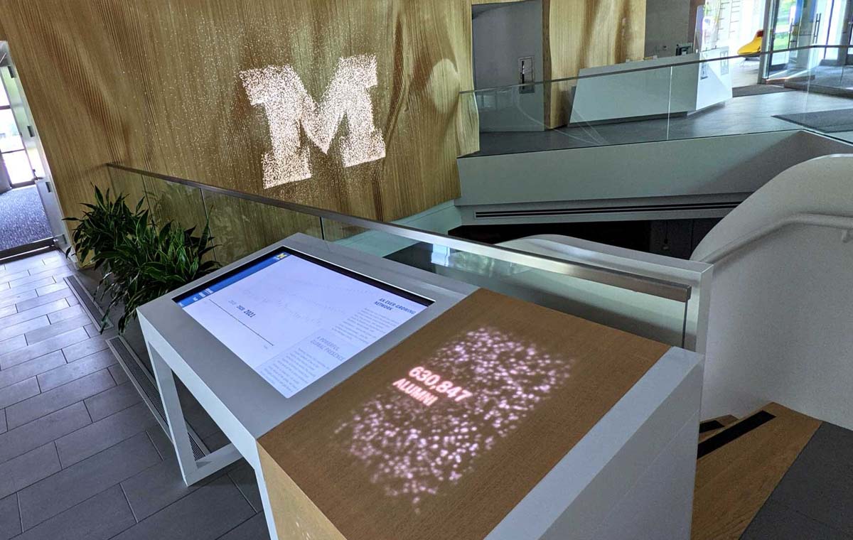 UM's Alumni Center welcomes guests with interactive media exemplifying a modern commercial interior