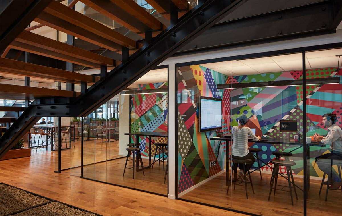 A glass enclosed employee lounge design in a modern corporate interior