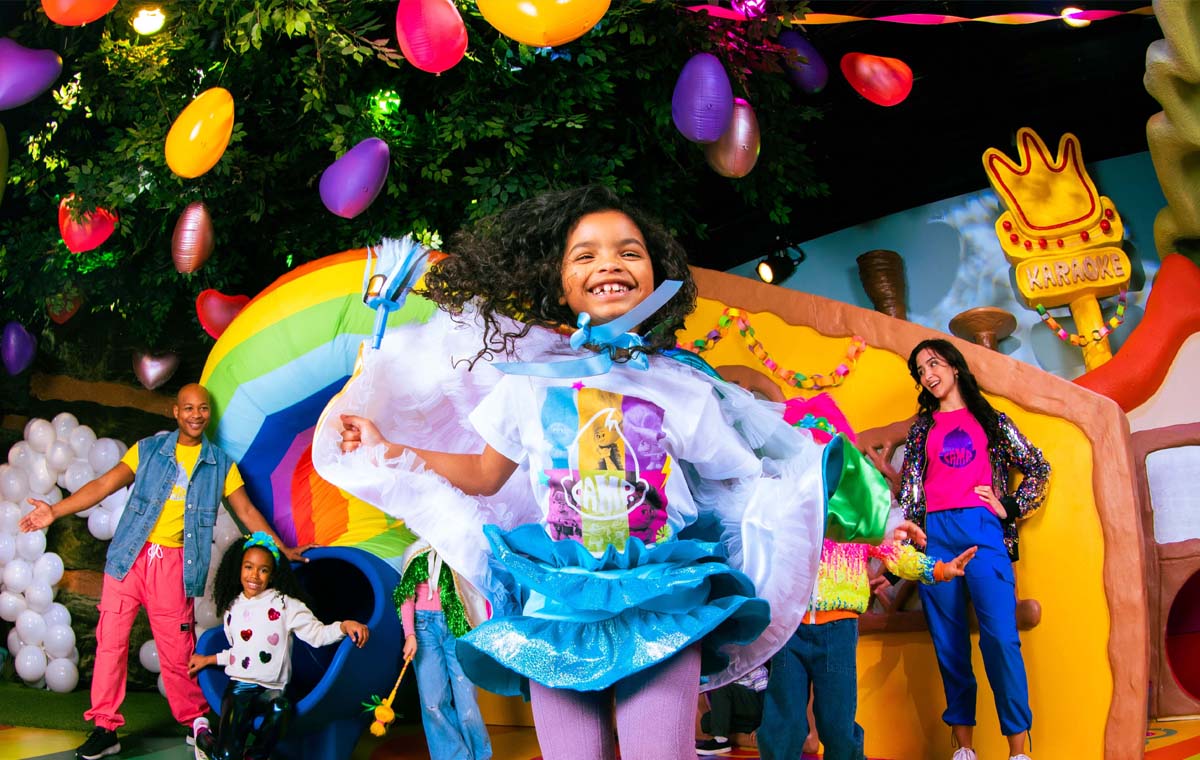 A young girl emerges smiling from one of Camp's Themed Entertainment activations